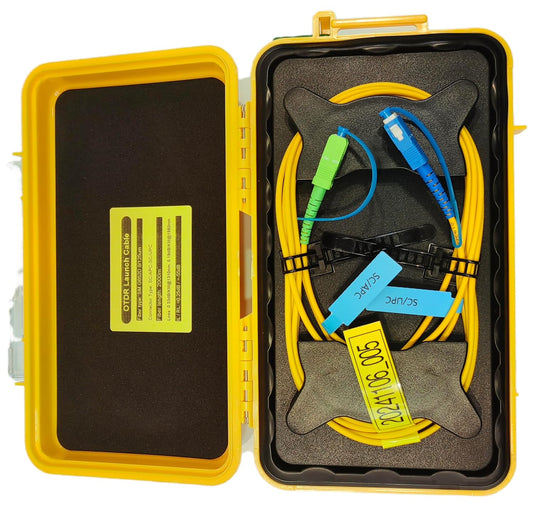 Yellow FIBAsource OTDR launch cable case with yellow fiber optic cables featuring green SC/APC and blue SC/UPC connectors from FIBAsource Ltd. Designed for telecom technicians, it comes with two black holders and a yellow data card inscribed with numbers and dates, making it perfect for precise fibre optic measurements and OTDR testing over its 2-kilometer single-mode extension.