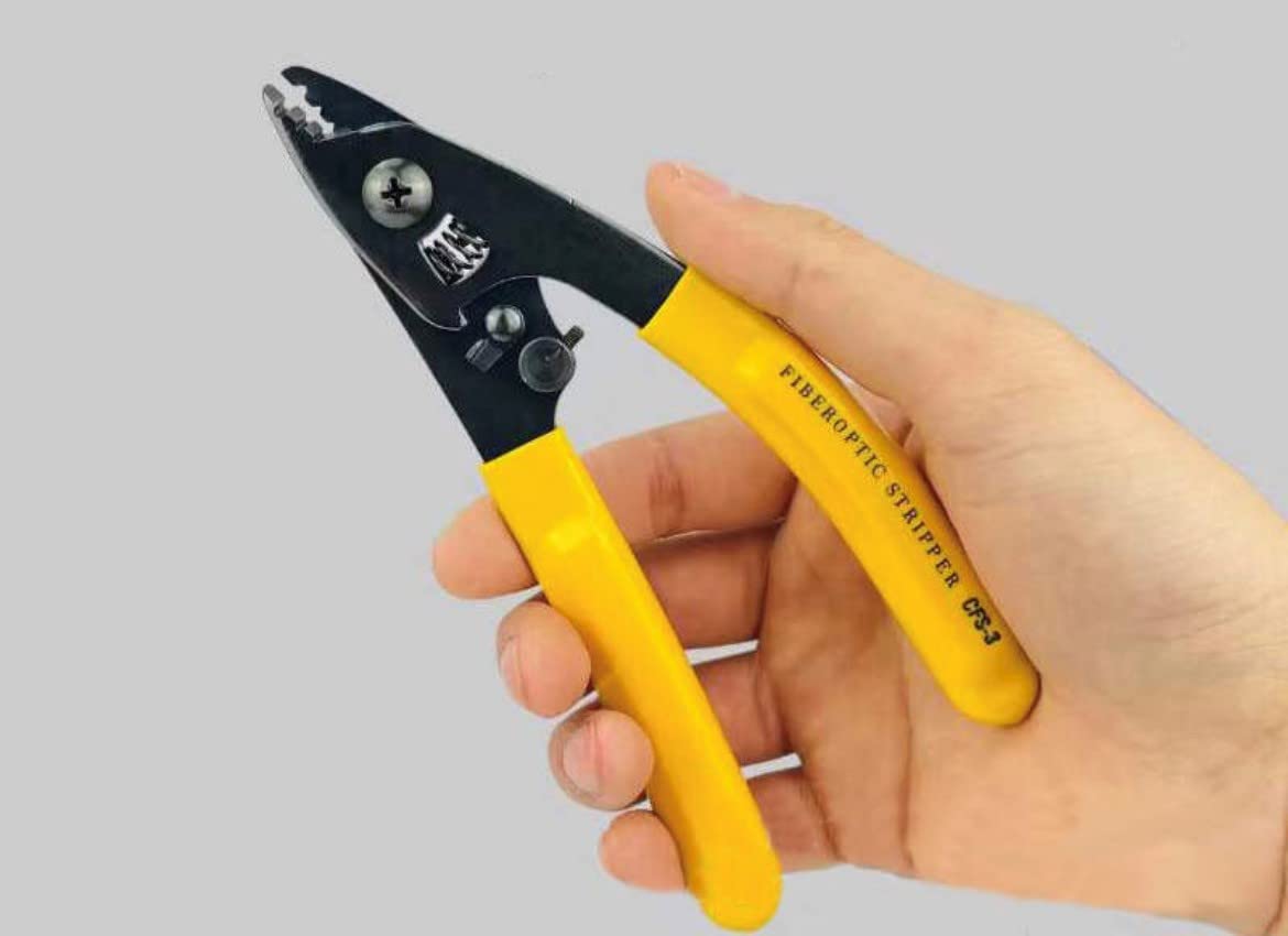 A hand grips the FIBAsource Ltd Fibre Optic Three Hole Pigtail Pliers with yellow handles against a plain background. This precision tool, resembling wire strippers, is specifically designed for efficiently removing insulation from optical fiber cables.