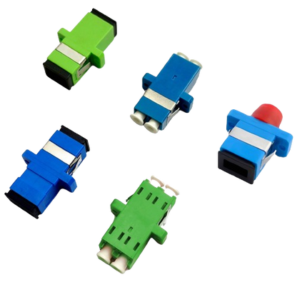 Five vibrant couplers from the Fibre Optic Coupler Series by FIBAsource Ltd are displayed on a white background: two green, two blue, and one red with blue. These couplers resemble patch panel adapters with distinctive shapes and connectors, arranged in an intriguing pattern across the surface.