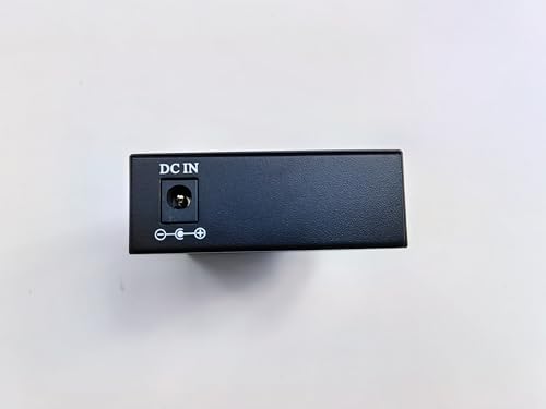 The SFP Ethernet Media Converter with POE Function, produced by FIBAsource Ltd, is a black electronic device that includes a DC IN power input port with polarity labeling. It is engineered for low power dissipation and efficient 100/1000Mbps transmission. The product is displayed against a plain white background.